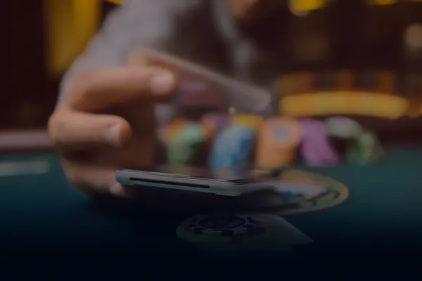 A person using their device against a moody casino-themed background, illustrating the smooth re-entry process at D63.